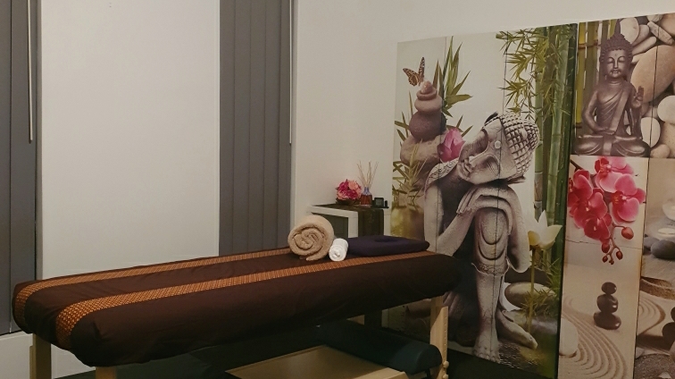 The treatment table from another angle, with the Buddha and orchid screen behind it